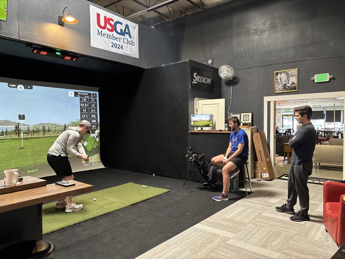 Group of friends watching a swing at a COR Golf private event