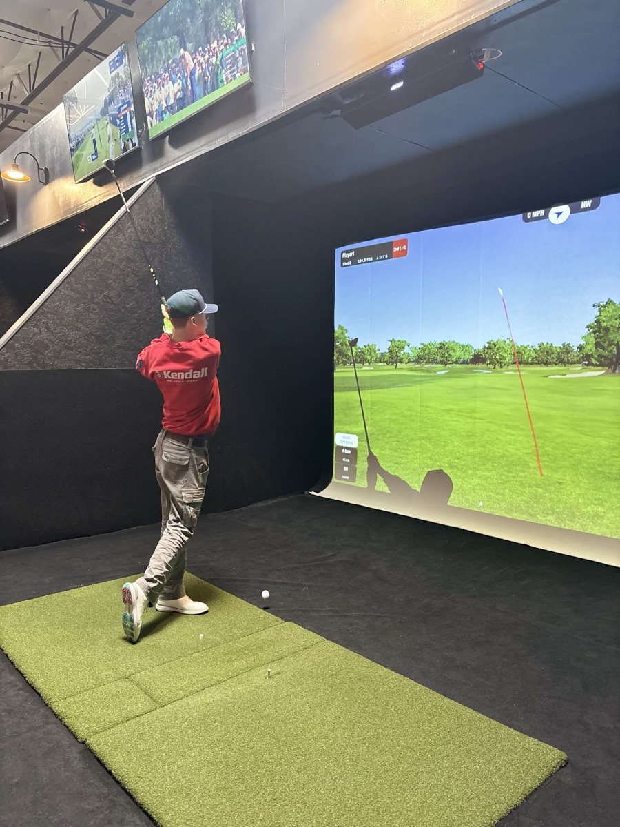 Follow-through on a COR Golf simulator bay