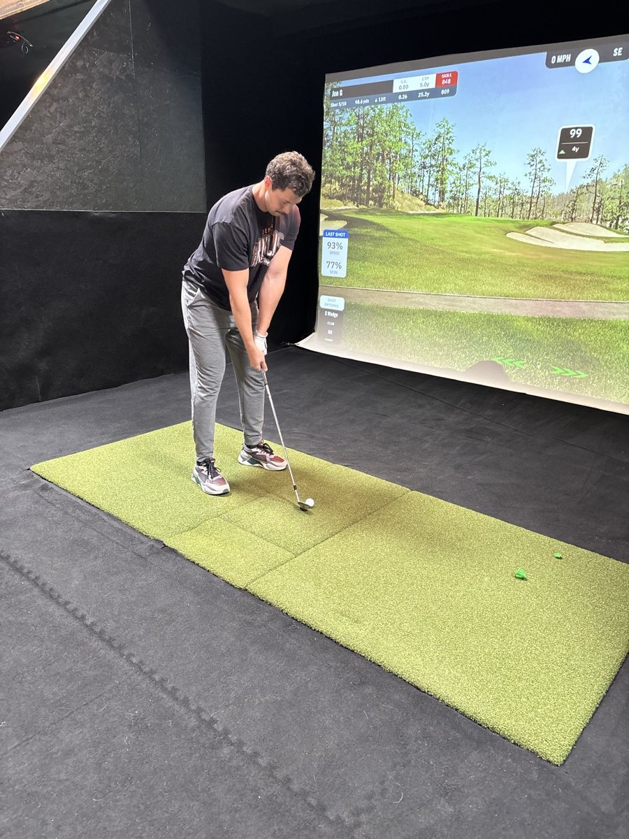 Iron shot on a COR Golf simulator bay