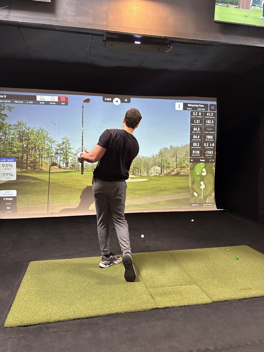 Golfer lining up a shot on a COR Golf simulator