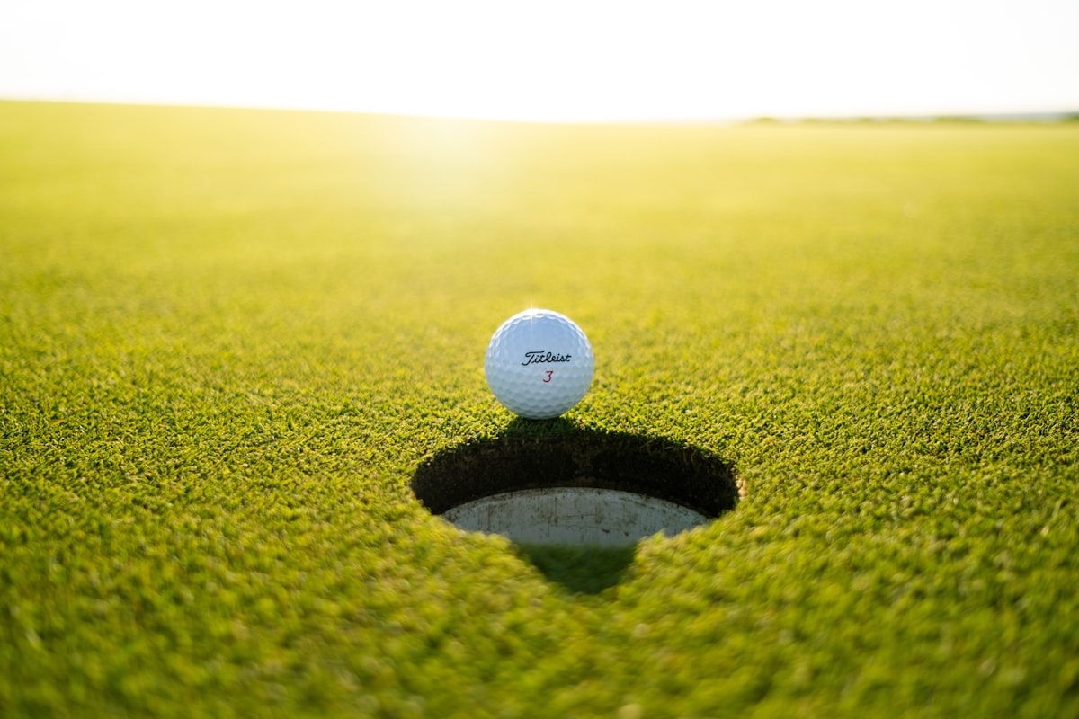 Golf ball on the lip of the hole