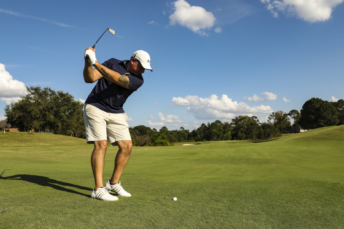 Golfer mid-swing on the course